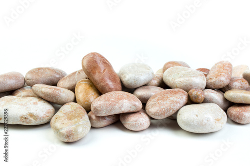 Small sea stones, isolated on white. Top view with copy space
