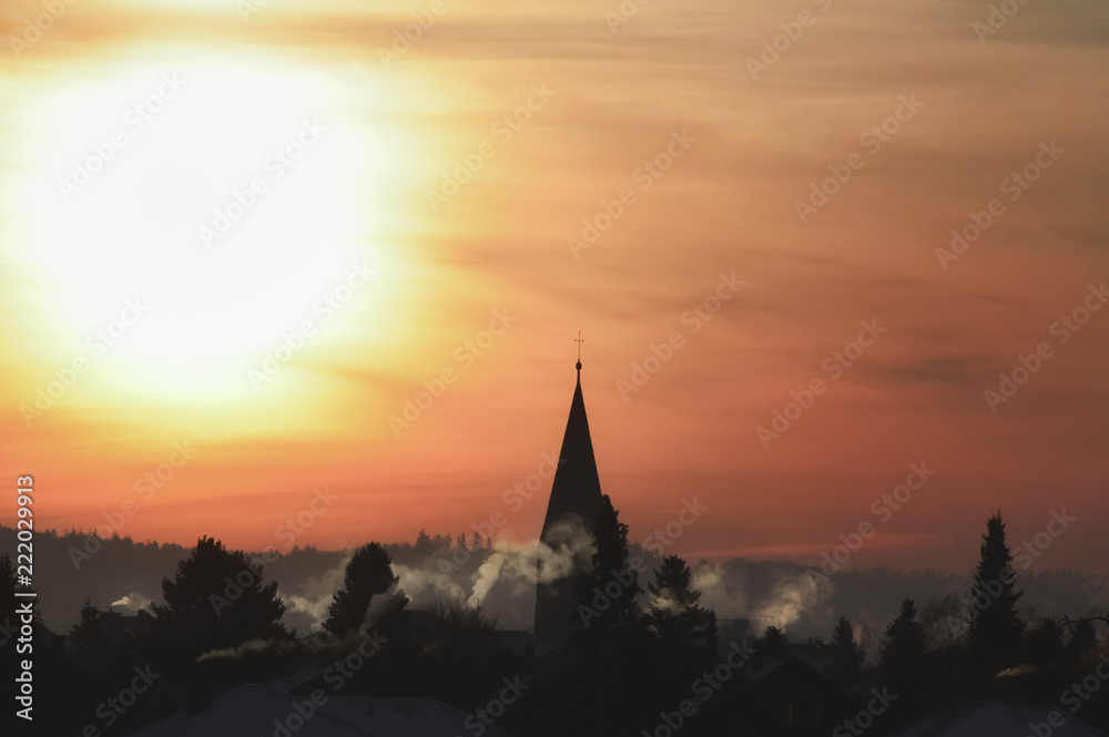 Village silhouette and colorful sunrise