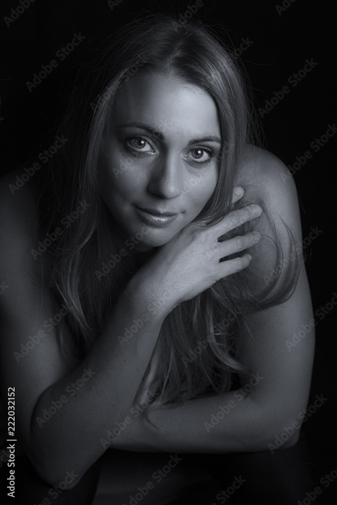 Fototapeta premium Beautiful woman emotional portrait in low light artistic conversion