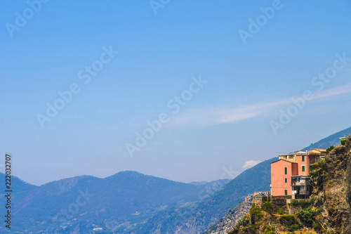 View over the blue Mediterranean Sea and the mountains of Cinque Terre, Italy on a sunny day with blue sky. © Spectral-Design