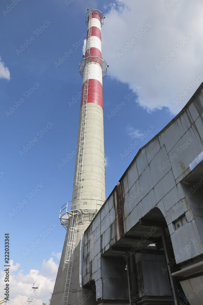 A high red-white concrete industrial chimney A high red-white concrete industrial chimney