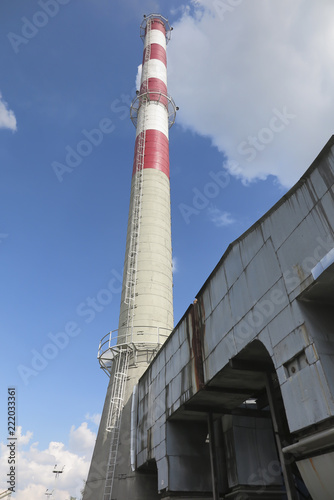 A high red-white concrete industrial chimney