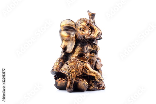 Gold Black Brown Engraved pattern gold elephant made of resin like wooden carving with white ivory. Stand on white background  Isolated  Art Model Thai Crafts  For decoration Like in the spa.