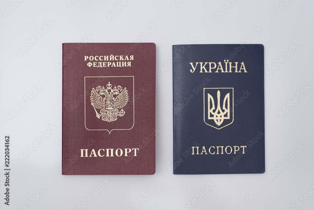 Ukrainian and Russian international passports. White background. Close up