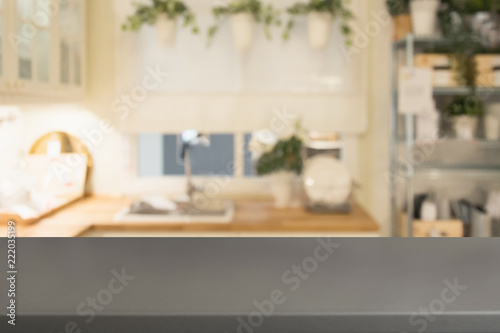 Blurred background. Modern defocused pastel kitchen with wooden tabletop and space for you.