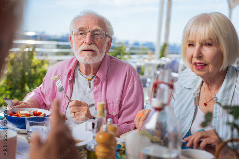 In the restaurant. Smart aged people having lunch with their friends while relaxing at the weekend In the restaurant. Smart aged people having lunch with their friends while relaxing at the weekend