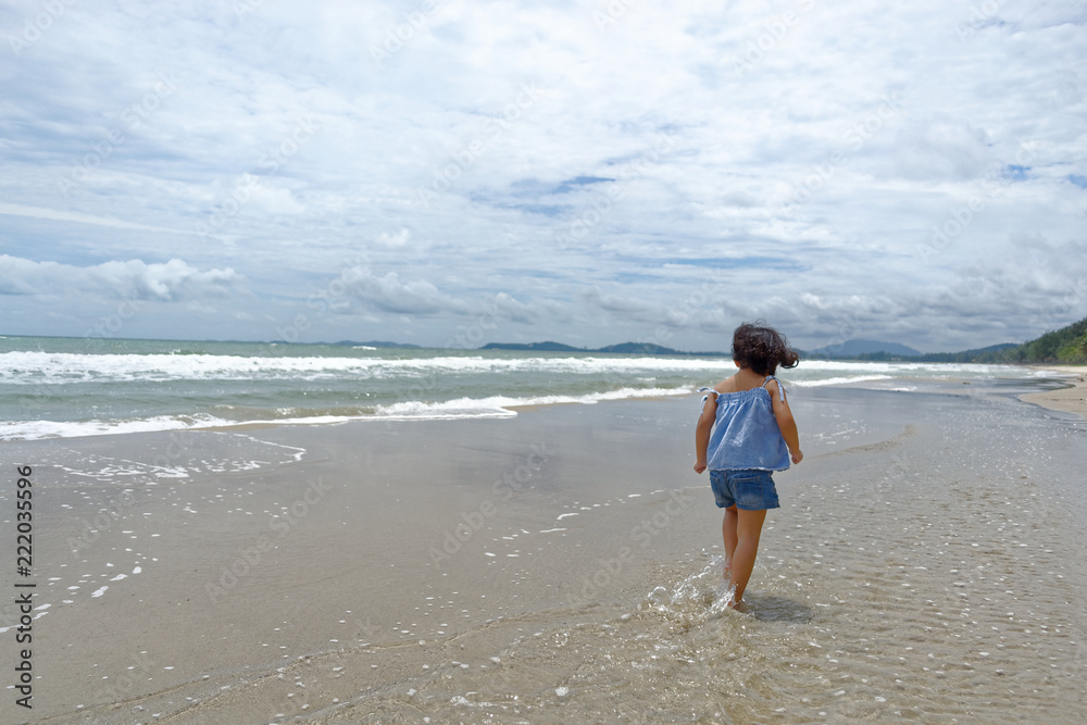 little girl funny happy on the beach 