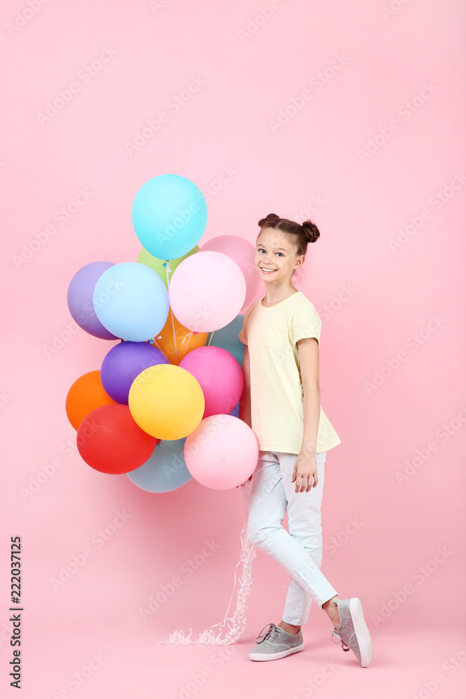 Cute young girl with colored balloons on pink background Cute young girl with colored balloons on pink background