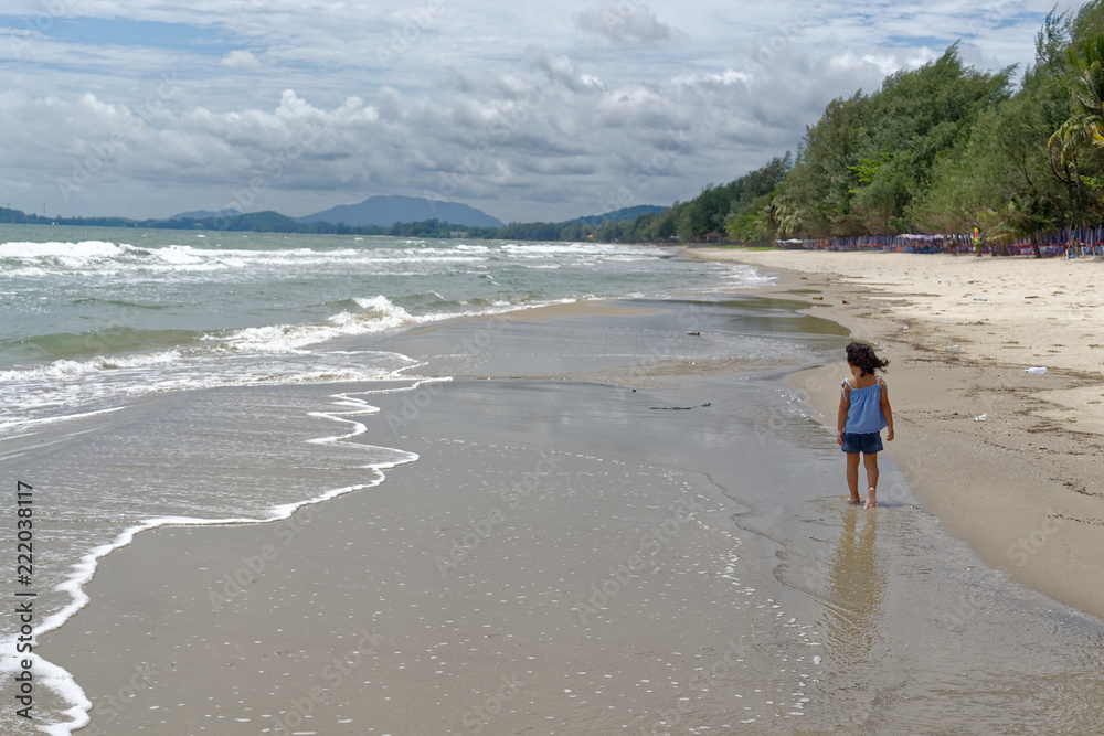 little girl walking relaxing on the beach  