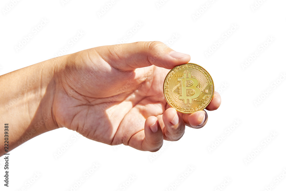 Fototapeta premium Woman’s hand holding golden Bitcoin on white background. Isolated on white. Business concept.
