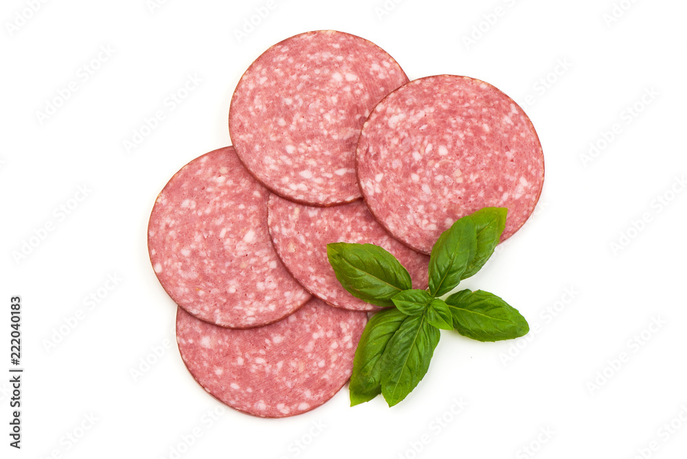 Dry salami sausage slices with basil leaves, isolated on white background. Top view.