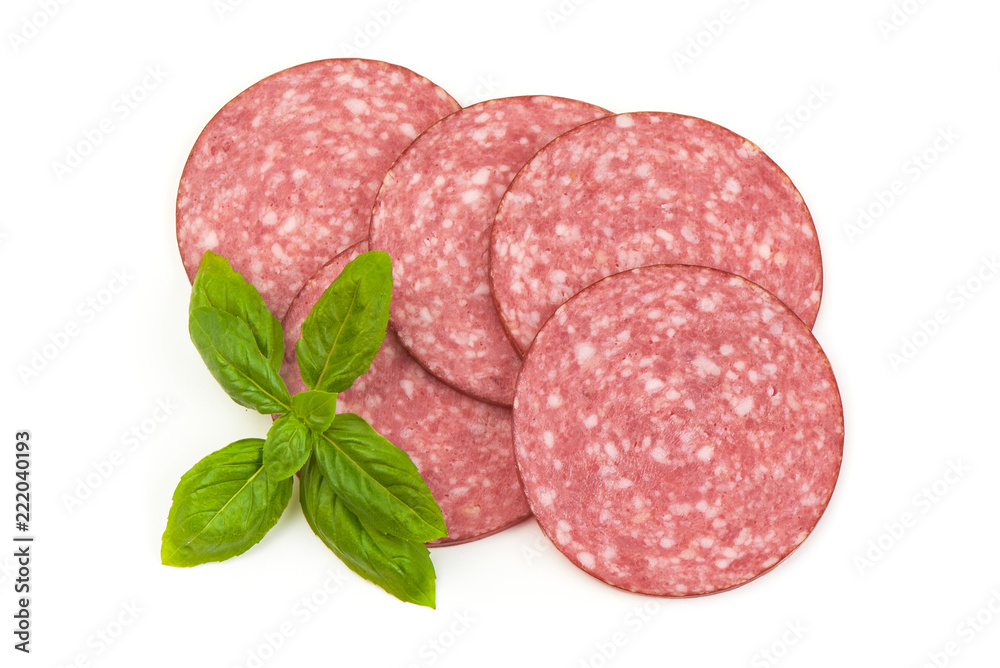 Dry salami sausage slices with basil leaves, isolated on white background. Top view. Dry salami sausage slices with basil leaves, isolated on white background. Top view.