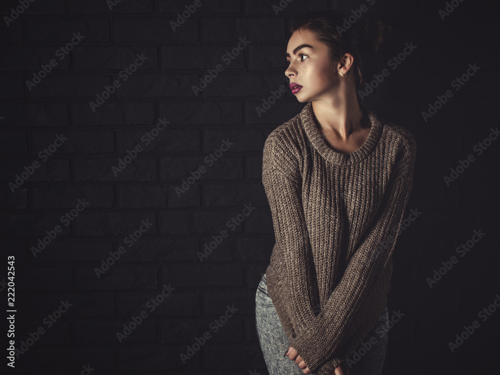Classic shot of a Sexy Woman wearing a Sweater off the Shoulder Classic shot of a Sexy Woman wearing a Sweater off the Shoulder