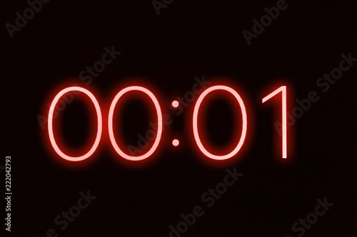 Digital clock timer stopwatch display showing 1 one second remaining in glowing red numbers. Emergency, urgency, out of time concept.