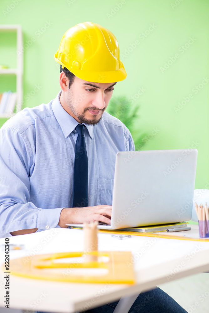 Young male architect working at the project Young male architect working at the project