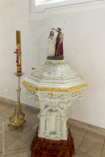 фотографія Kamien Slaski, Poland, August 28, 2018: Old baptismal font at St