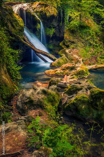Beautiful waterfall with rocks in foreground and moss photo