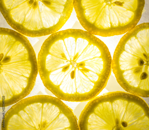 Top view of bright yellow lemon slices