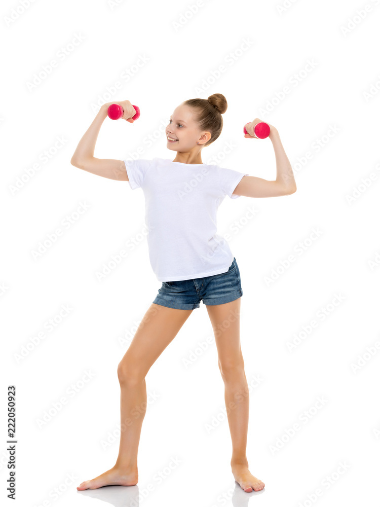 Little girl doing exercises with dumbbells. Little girl doing exercises with dumbbells.