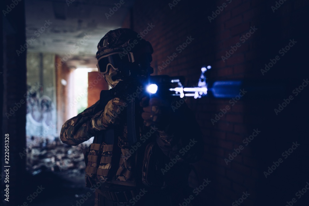 Peacekeepers in helmets and balaclava, holding an assault rifle pitselivaetsya at night in the dark Peacekeepers in helmets and balaclava, holding an assault rifle pitselivaetsya at night in the dark