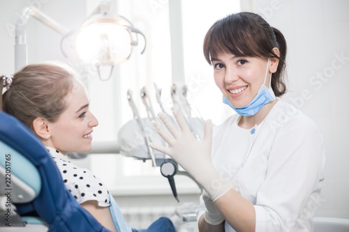Dentist in white uniform prepare for the treatment of the patient's teeth wear latex gloves