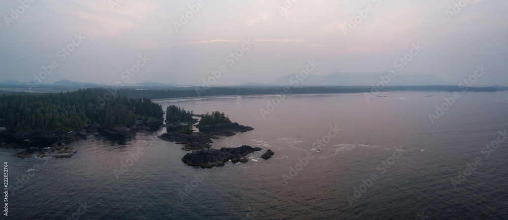 Aerial panoramic seascape view of Pacific Ocean Coast during a cloudy summer sunrise. Taken near Tofino and Ucluelet, Vancouver Island, BC, Canada.