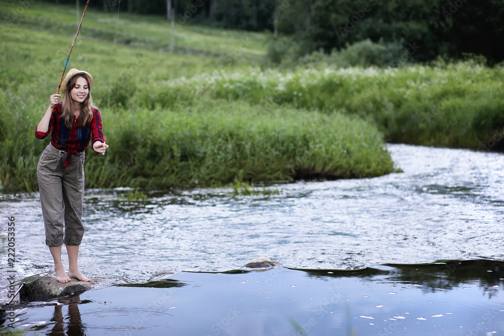 Girl by the river with a fishing rod Girl by the river with a fishing rod