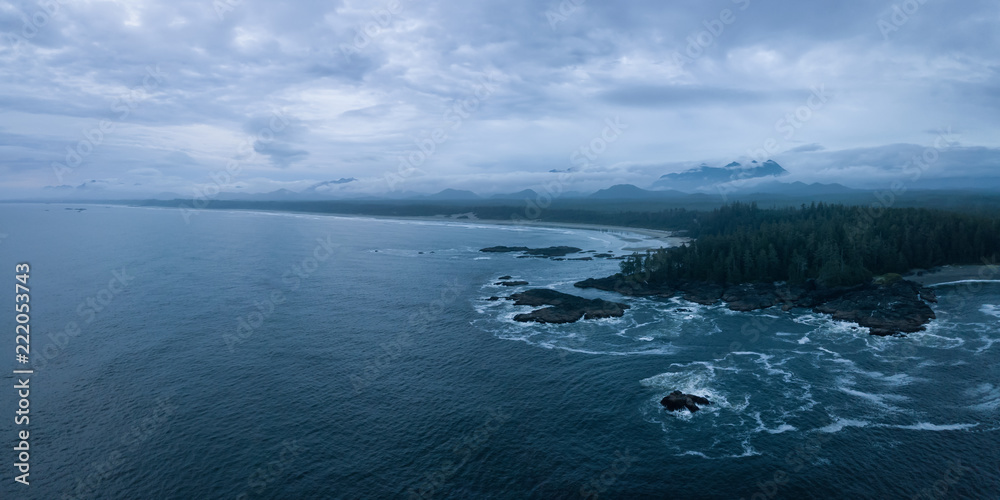 Aerial panoramic seascape view of the Pacific Ocean Coast during a cloudy summer sunset. Taken near Tofino and Ucluelet, Vancouver Island, BC, Canada.