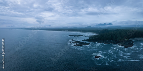 Aerial panoramic seascape view of the Pacific Ocean Coast during a cloudy summer sunset. Taken near Tofino and Ucluelet, Vancouver Island, BC, Canada.