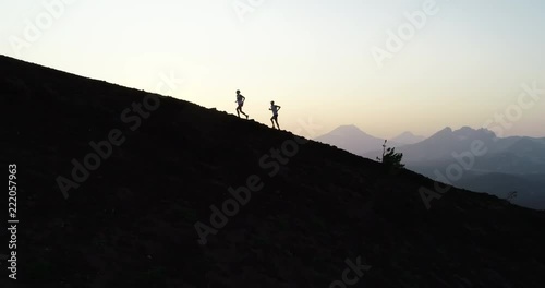 Runners at sunset on a mountain