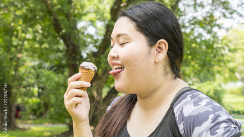 fat girl eat ice cream in close up face feeling delicious photo