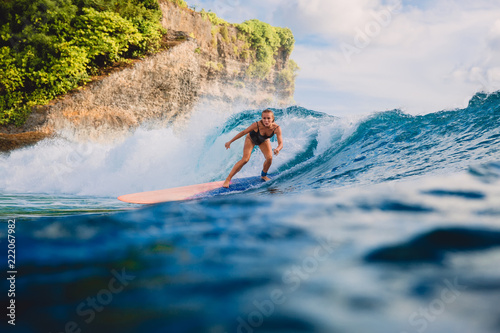Surf girl on long surfboard. Woman in ocean during surfing. Surfer and ocean wave