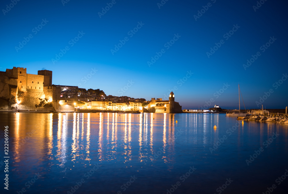 Beautiful small bay with old church of Our Lady of the Angels in the Collioure at late evening.