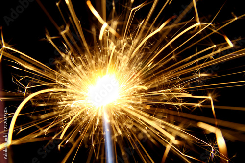 Firework background   A sparkler is a type of hand-held firework that burns slowly while emitting colored flames  sparks  and other effects