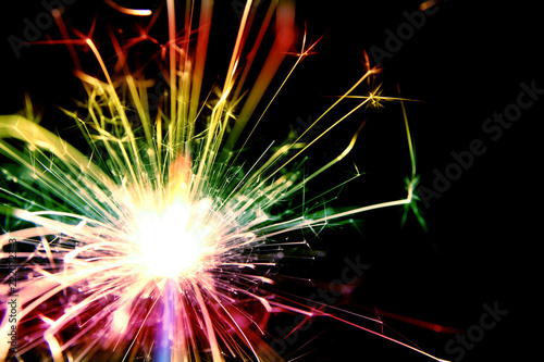 Firework background   A sparkler is a type of hand-held firework that burns slowly while emitting colored flames  sparks  and other effects