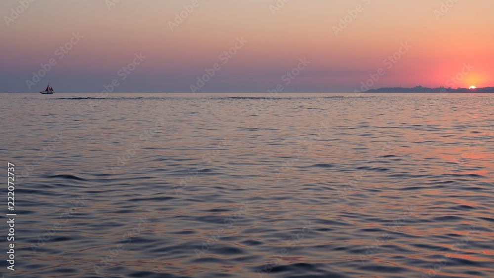 sunset sea and sailboat