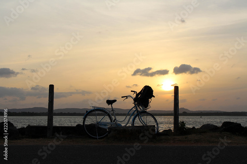 A bicycle and sunset around Bendiwewa Lake in Polonnaruwa photo