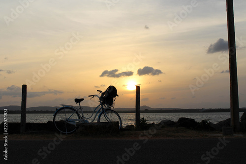 A bicycle and sunset around Bendiwewa Lake in Polonnaruwa photo