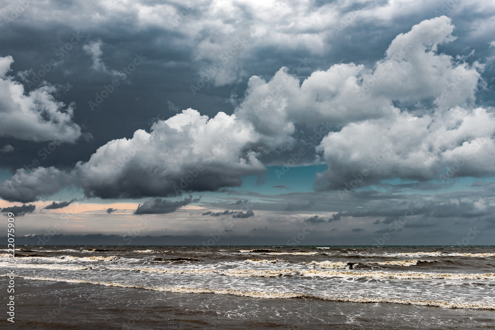 Beautiful sky with dense clouds over the stormy sea