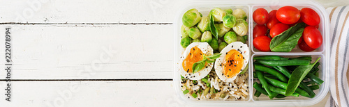 Vegetarian meal prep containers with eggs, brussel sprouts, green beans and tomato. Dinner in lunch box. Banner. Top view. Flat lay