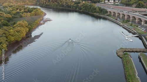 Aerial view of the Raritan River flowing through New Brunswick, New Jersey. Someone on a jestski has fun on the river. photo