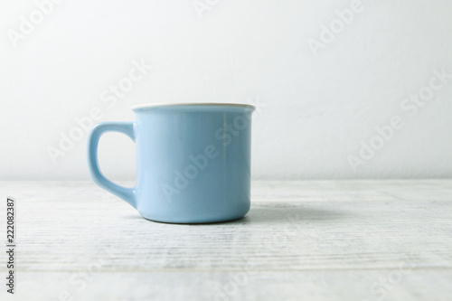 Blue mug on white wooden table