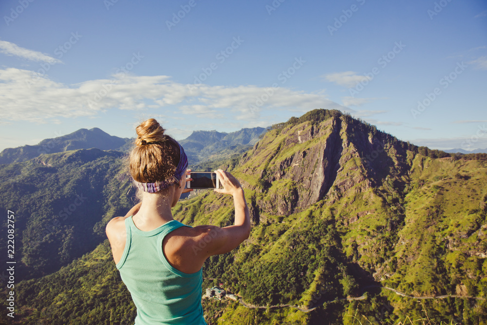 A woman takes pictures of the mountains A woman takes pictures of the mountains