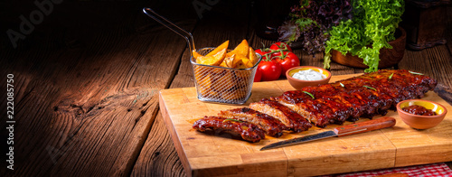 BBQ spare ribs from a charcoal grill photo