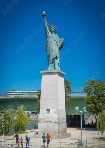 Paris, France - 08 18 2018:  Les Quais de Seine - Bateau mouche et Statue de la liberté