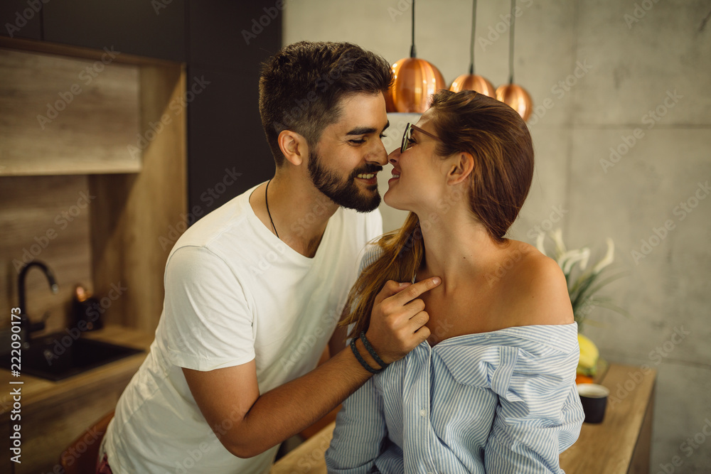 Couple in love spending time together in the house. Romantic moments in the  kitchen. Stock Photo