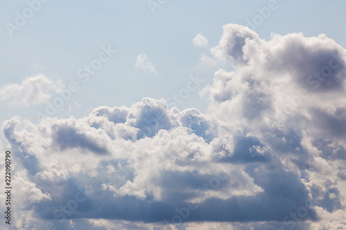 Cumulonimbus clouds in blue sky illuminated on the right