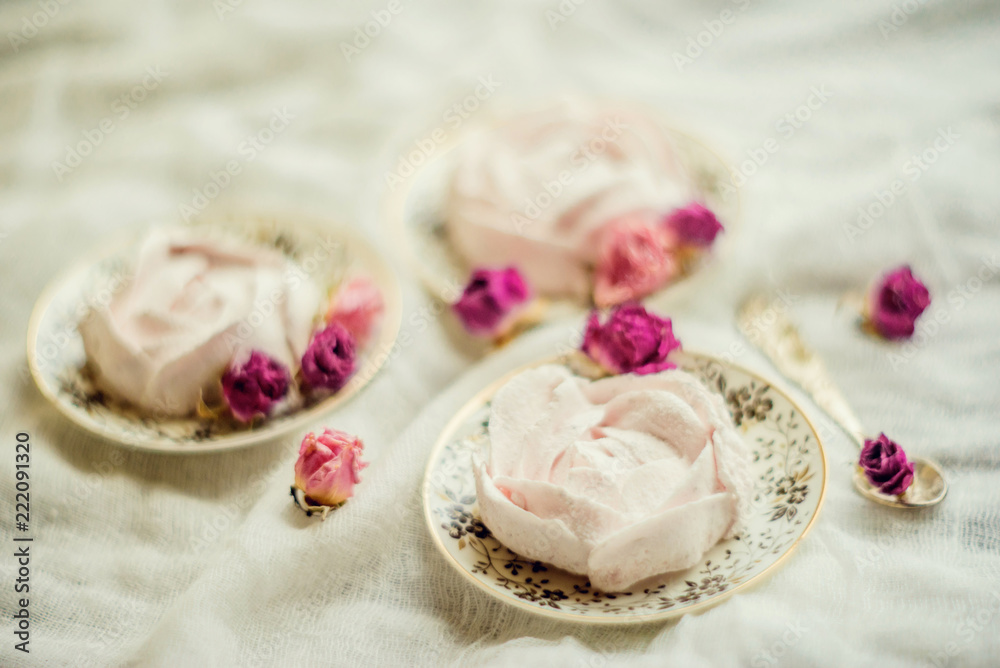 Homemade marshmallow in the shape of a rose on a textile background