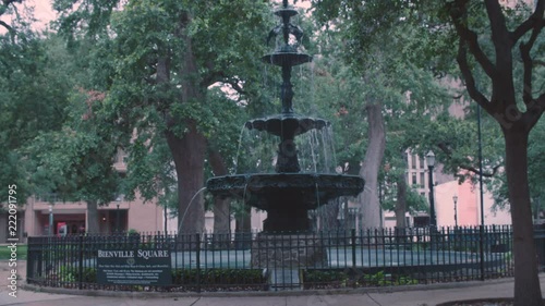 A seagull flies near a full shot of the Bienville Square fountain in Mobile, Alabama. photo