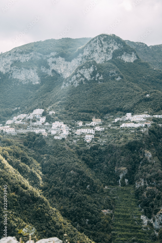 The Amalfi coast and the mountain slopes with plantations of lemons. Panoramic view of the city and nature of Italy. Evening landscapes and winding roads The Amalfi coast and the mountain slopes with plantations of lemons. Panoramic view of the city and nature of Italy. Evening landscapes and winding roads